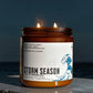 A candle with the name, Storm Season on it