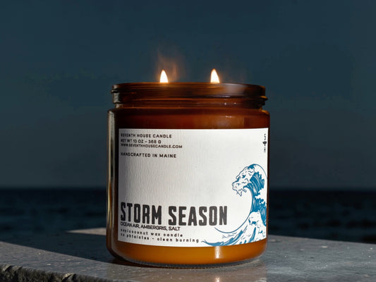 A candle with the name, Storm Season on it
