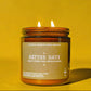 Candle in a glass jar with a label on a yellow background