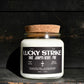 A Clear candle with the name Lucky Strike on it