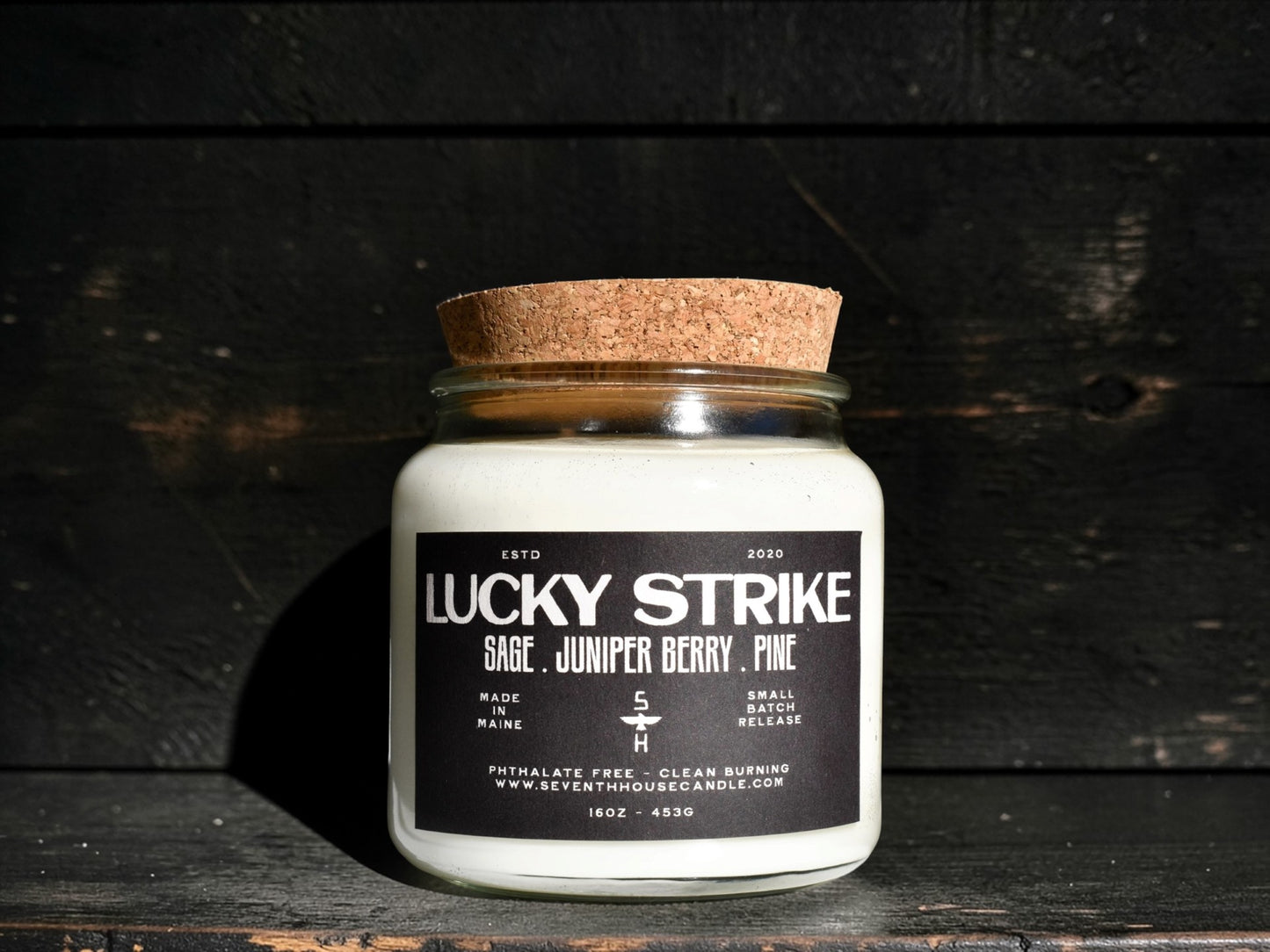 A Clear candle with the name Lucky Strike on it