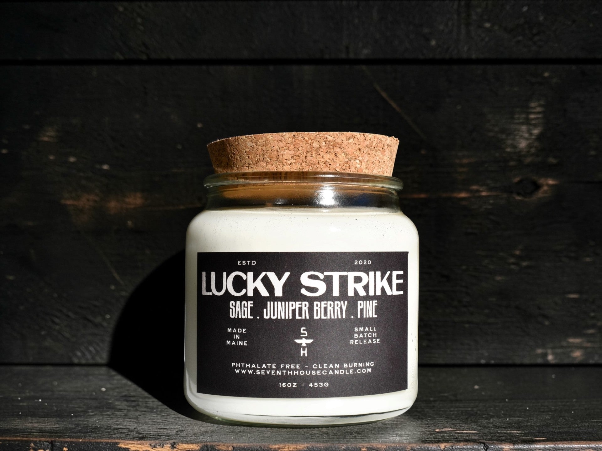 A Clear candle with the name Lucky Strike on it