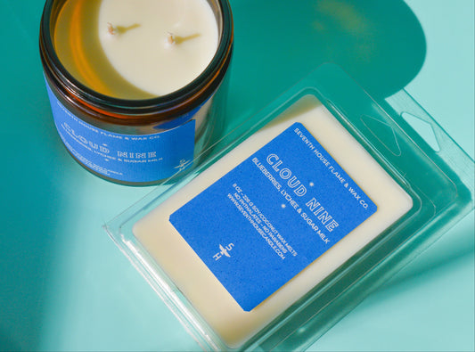 Candle with a wax melt next to it with the label reading, Cloud Nine".