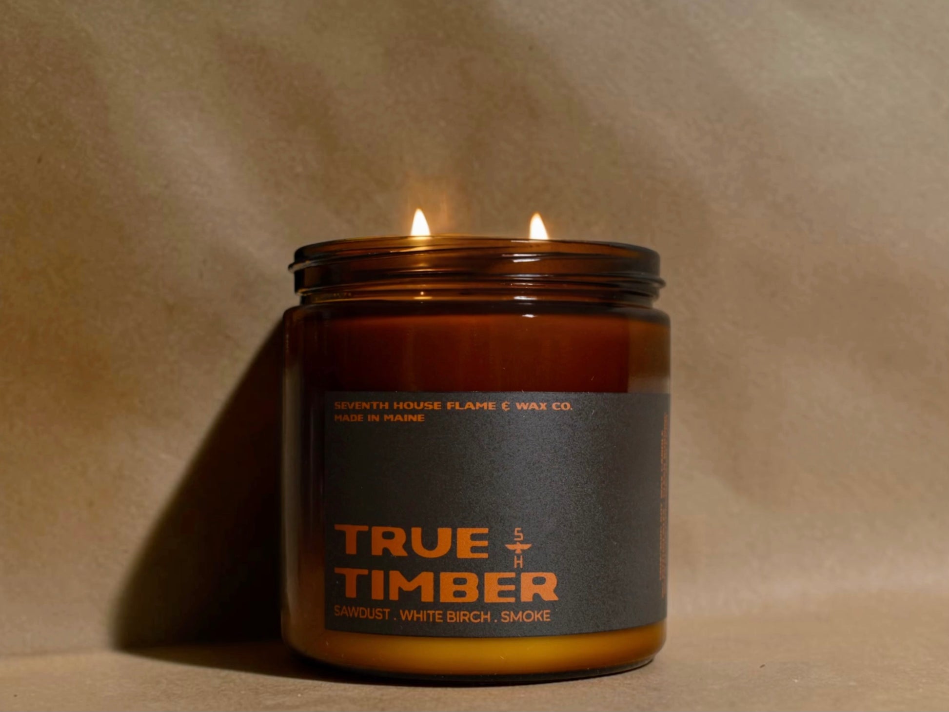 A amber colored jar with the label reading, True Timber.