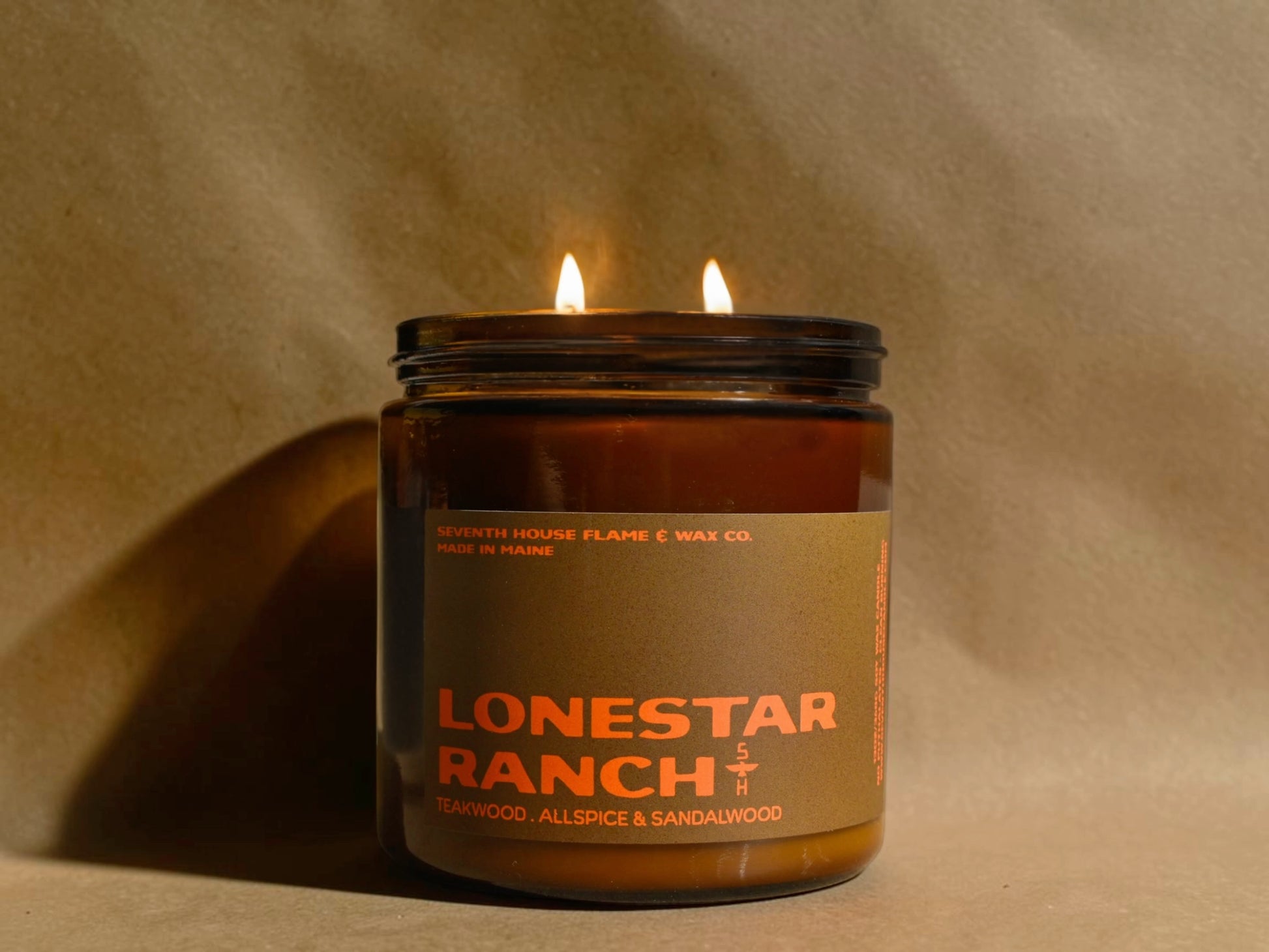 Candle in a jar labeled 'Lonestar Ranch' on a beige background
