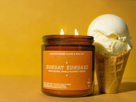 Candle labeled 'Sunday Sundaes' next to an ice cream cone on a yellow background