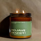 Candle in a jar labeled 'Mojave Desert' with a green label on a brown background