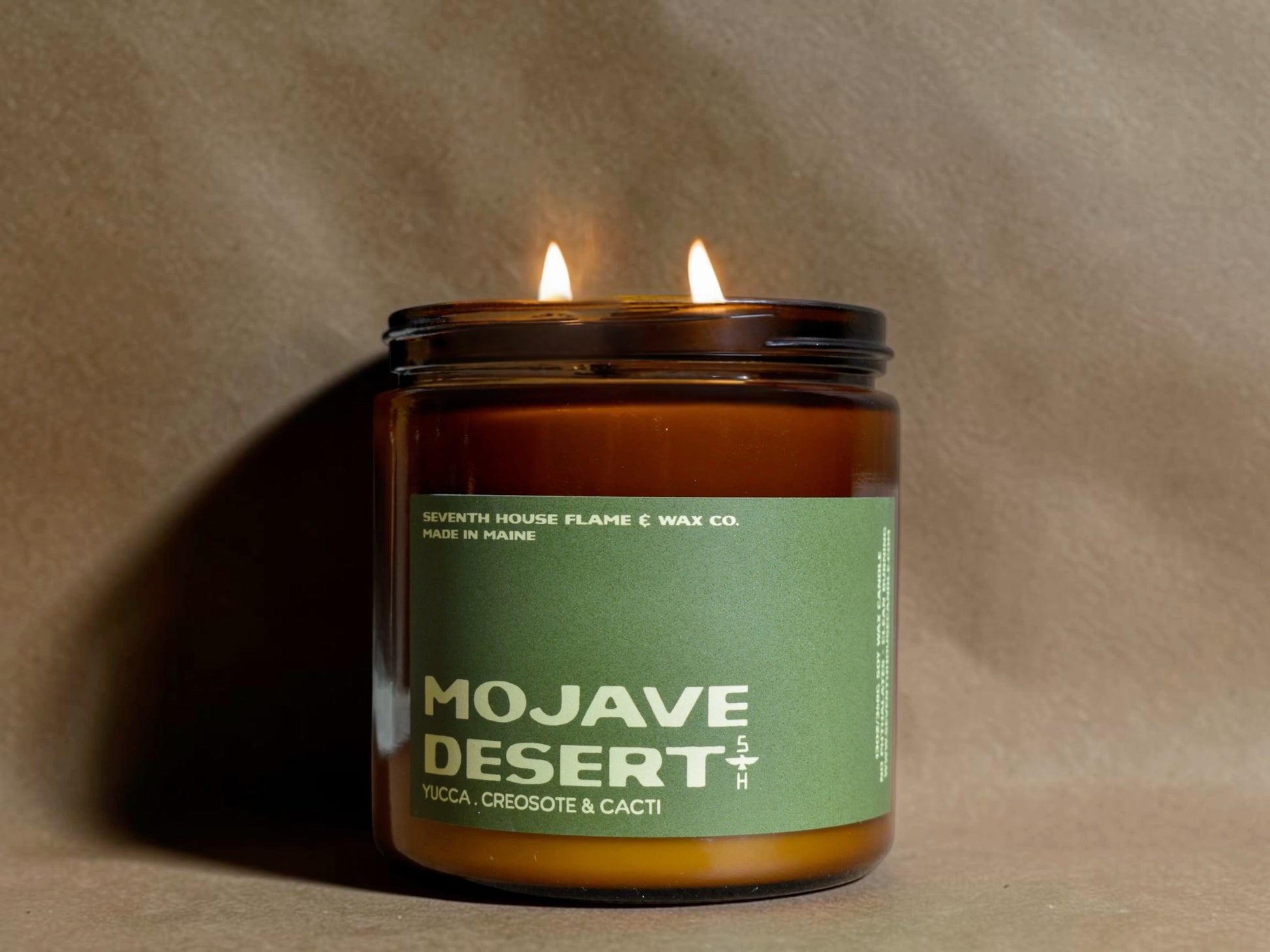 Candle in a jar labeled 'Mojave Desert' with a green label on a brown background