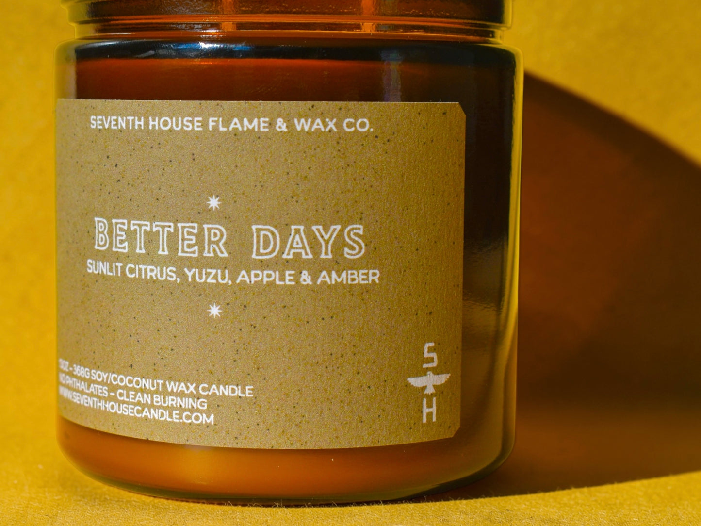 Candle jar with 'Better Days' label on a yellow background